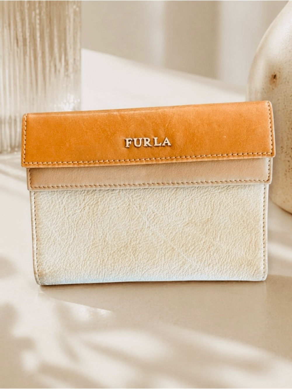 FURLA Leather Double Snap Two
Tone Wallet featuring classic neutral colors.